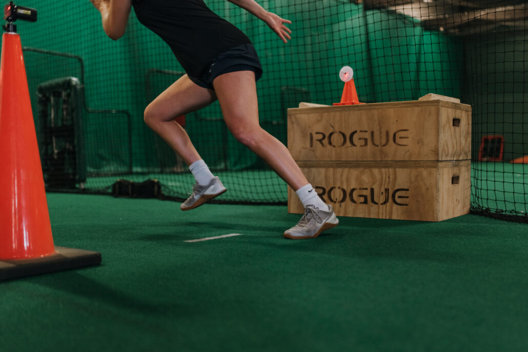 athlete running on turf for summer speed camp